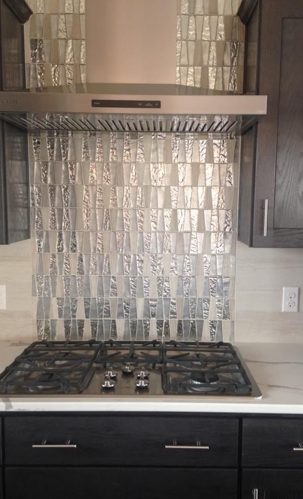 Tile backsplash behind stovetop installation